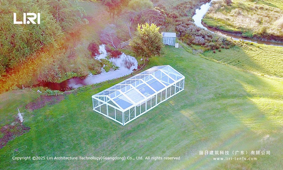 Aerial view of a clear top event tent beside a pond